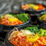 An interactive dining scene with a DIY bibimbap setup, including bowls of various fresh ingredients like spinach, mushrooms, carrots, and bean sprouts, alongside cooked rice and gochujang, inviting guests to create their own customized bibimbap bowls.