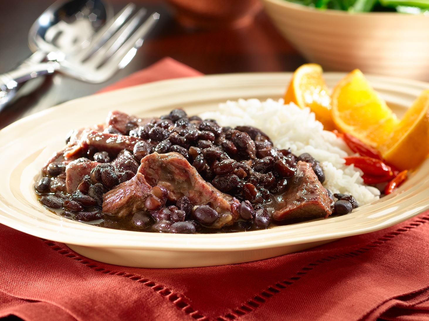 Close-up of a hearty feijoada stew, featuring tender pork pieces and black beans